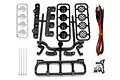 Team Associated XP LED roof light kit components including plastic light housings, lenses, wire harness with four LEDs, zip ties, and mounting screws.
