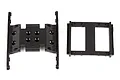 Two black plastic RC chassis components, a gearbox mount and a servo mount, isolated on a white background.