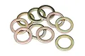A group of ten gold-colored metal washers scattered on a white background.