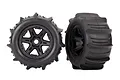 Two Traxxas 3.8 inch paddle tyres pre-glued onto black six-spoke RC wheels, shown from front and side angles.