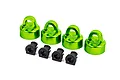 Four green anodized aluminium shock caps and four black plastic spacers for Traxxas RC vehicles.