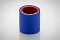 A short, cylindrical blue silicone hose connector with a reddish-brown interior lining, standing upright against a white background.