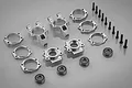 Rovan silver aluminium rear hub carriers and shim kit including various metal components, screws, and ball bearings arranged on a grey background.