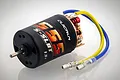 Hobbywing Quicrun 555 13T brushed RC motor with black casing, red end bell details, and blue and yellow wires with bullet connectors.