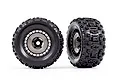 Two Traxxas 3.8 inch Sledgehammer RC monster truck tires pre-glued onto black and grey modular wheels, shown from front and angled views.