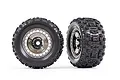 Two Traxxas 3.8 inch Sledgehammer RC monster truck tires mounted on black chrome modular wheels, shown from front and angled side views.