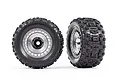 Two Traxxas 3.8 inch Sledgehammer tires pre-mounted on satin chrome modular wheels against a white background.