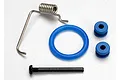 Traxxas fuel tank rebuild kit components including a metal spring, a blue O-ring, two blue rubber grommets, and a black machine screw.