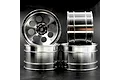 Four silver aluminium RC car rims with an 8-spoke design stacked against a dark background.