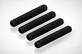 Four black metal grub screws with fine threads arranged in a diagonal row on a white background.