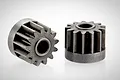 Two 13-tooth metal transmission gears for RGT RC vehicles, shown against a plain white background.