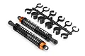 Two HPI Racing RC buggy rear shock absorbers with black springs and orange collars, accompanied by a plastic tree of shock preload spacers.