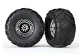 Two Traxxas Terra Groove RC monster truck tyres mounted on chrome deep-dish rims against a white background.