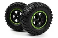 Two BlackZon 1.9 inch RC desert truck wheels with black spoked rims, green beadlock-style rings, and aggressive treaded rubber tyres.
