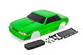 Traxxas 1/10 scale Ford Mustang Fox body shell in bright green with included black spoiler, side mirrors, foam bumper, and mounting hardware.