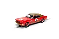 A 1/32 scale Scalextric Ford Mustang slot car in red and gold livery with number 6, shown on a track section.