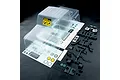 Clear unpainted MST JP1 RC crawler body shell with included decal sheet, plastic accessory parts, and hardware on a black background.