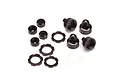 A set of dark brown anodized aluminium RC shock absorber parts including caps, collars, and small washers on a white background.