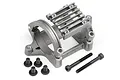 A silver cast metal RC motor mount with cooling fins and four short black screws and two long black socket head screws on a white background.