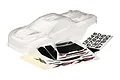 A clear, unpainted Traxxas XRT RC truck body shell shown with included decal sheets on a white background.