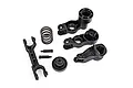 Traxxas steering bellcrank and drag link assembly parts including plastic arms, a metal spring, and small screws on a white background.