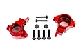 A pair of red anodized aluminium steering hubs for Traxxas RC vehicles, accompanied by mounting screws and lock nuts on a white background.