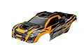 A pre-painted orange and black Traxxas XRT RC truck body shell featuring aggressive racing graphics and a sleek, aerodynamic design.