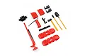 A set of 1/18 scale RC rock crawler accessories including a jack, fuel cans, fire extinguisher, shovel, axe, and recovery boards on a white background.