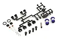 Kyosho unassembled aluminium shock absorber set including two blue anodized shock bodies, plastic parts on a sprue, metal shafts, and small hardware.