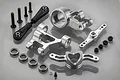Rovan silver aluminium steering and servo saver upgrade kit for RC cars, including metal steering arms, ball joints, bearings, and hardware.