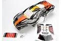 Traxxas Nitro Rustler ProGraphix body shell in orange and black with a decal sheet and small hardware parts on a white background.