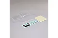An unpainted clear polycarbonate RC crawler body shell with two decal sheets and a mask sheet on a plain grey background.