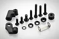 A collection of black metal screws, washers, plastic mounts, and a silver metal bracket for RC engine assembly.