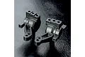 Two black plastic MST MB rear hubs for RC cars, shown from different angles on a textured black surface.