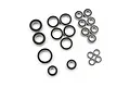 A collection of various sized metal ball bearings with black rubber seals arranged on a white background.