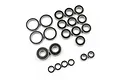 A collection of various sized rubber shielded ball bearings arranged on a white background.