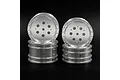 Four silver aluminium RC buggy rims stacked against a black background.