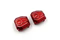 Two red anodized aluminium differential covers for RC cars by Yeah Racing, featuring the YR logo and a machined design.