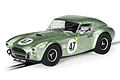 A metallic green Scalextric 1/32 scale Shelby Cobra 289 slot car, number 47, on a track.