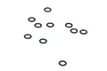A collection of ten small, thin black washers scattered on a plain white background.