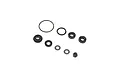 A collection of small RC shock rebuild parts including O-rings, plastic spacers, metal washers, and a lock nut on a white background.