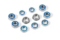 A collection of various sized metal ball bearings with blue rubber seals arranged on a white background.