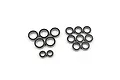 A collection of various sized rubber shielded ball bearings arranged on a white background.