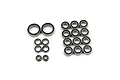 A collection of various sized rubber shielded ball bearings for RC cars arranged on a white background.