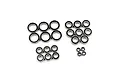A collection of various sized rubber shielded ball bearings arranged in groups on a white background.