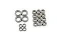 A collection of various sized metal shielded ball bearings arranged in groups on a white background.