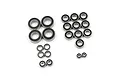 A collection of various sized rubber shielded ball bearings for RC cars arranged on a white background.