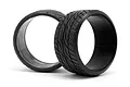 Two black HPI Racing drift tyres with a directional tread pattern, shown from a side-angle view against a white background.