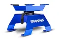 A blue anodized aluminium Traxxas RC work stand with a rotating top plate and black adjustment lever on a white background.