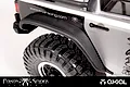 Close-up of an RC crawler rear fender flare installed on a silver vehicle body with a black tire and wheel.